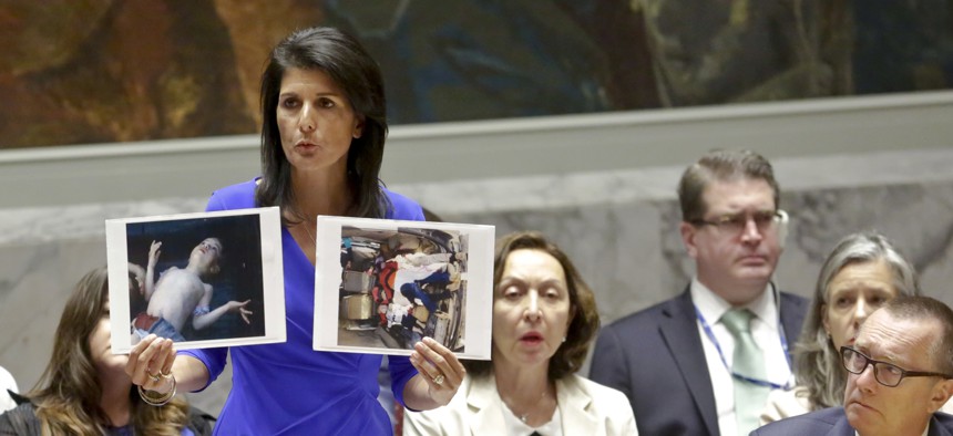 Nikki Haley, United States' Ambassador United Nations, shows pictures of Syrian victims of chemical attacks as she addresses a meeting of the Security Council on Syria at U.N. headquarters, Wednesday, April 5, 2017. 