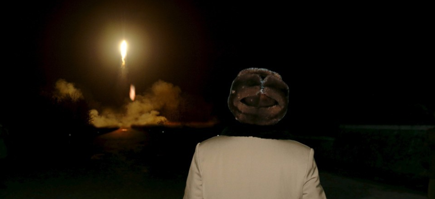 North Korean leader Kim Jong-Un watches a ballistic rocket launch.