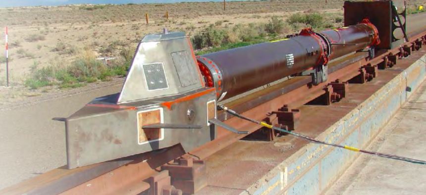 A monorail dry-run test at Holloman Air Force Base in July 2013 had no payload and used three representative carbon-epoxy panels mounted on the top and sides of the sled.