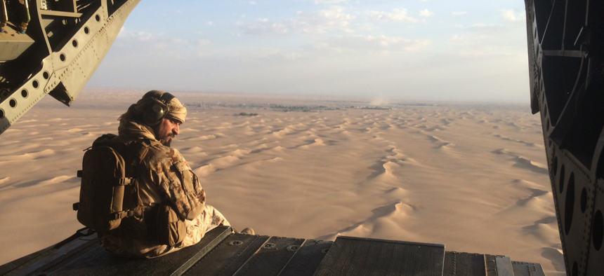 In this Sept. 17, 2015 photo, an Emirati gunner watches for enemy fire from the rear gate of a United Arab Emirates Chinook military helicopter flying over Yemen.