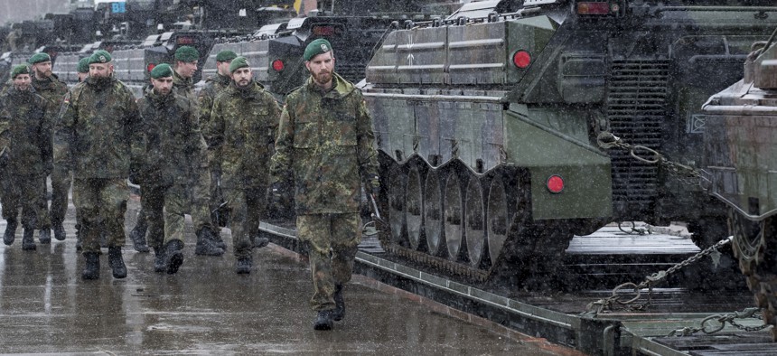 Troops from Germany's 12th Mechanised Infantry Brigade walks past Marder 1A4/3 military vehicles at the Sestokai railway station some 175 kms (109 miles) west of the capital Vilnius, Lithuania on Feb. 24, 2017.