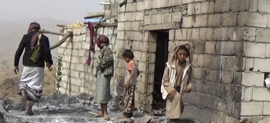 In this Feb. 3, 2017 frame grab from video, residents inspect a house that was damaged during a Jan. 29, 2017 US raid on the tiny village of Yakla, in central Yemen.