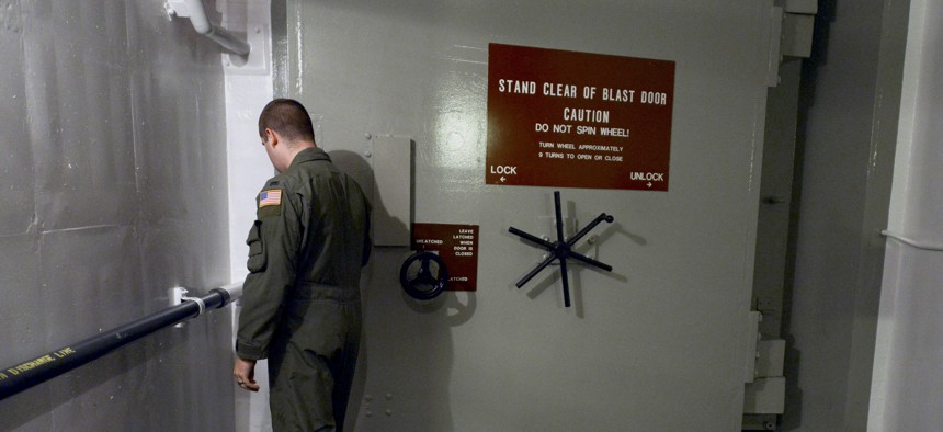 In this photo taken June 24, 2014, 1st Lt. Phil Parentrau opens the first of two blast doors leading to the underground control room at an ICBM launch control facility near Minot, N.D.