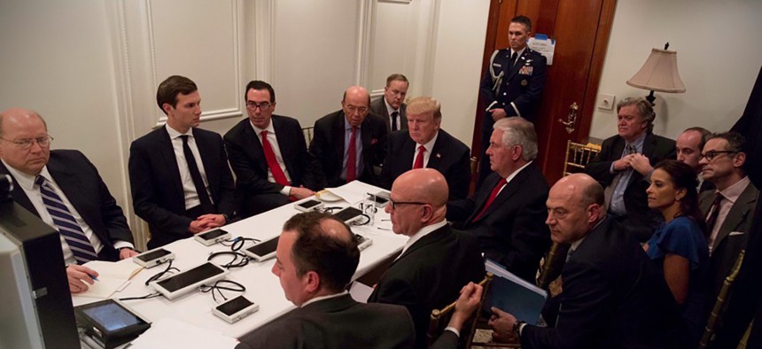U.S. President Donald Trump is shown in an official White House handout image meeting with his National Security team at his resort in Mar-a-Lago, on April 6.