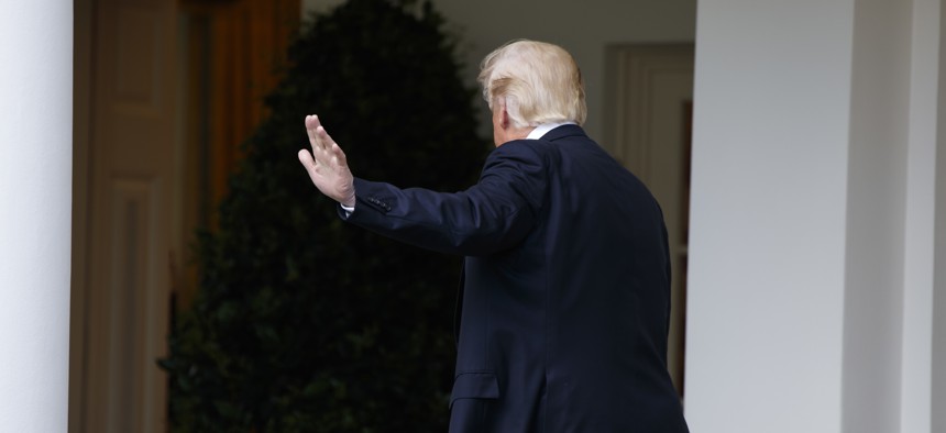 President Donald Trump waves as he walks to the Oval Office of the White House in Washington, Tuesday, May 2, 2017. 