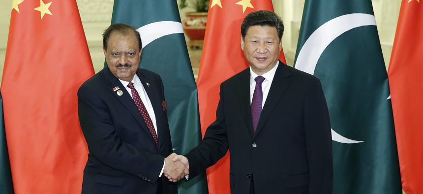 In this 2015 photo, Chinese President Xi Jinping, right, shakes hands with Pakistan President Mamnoon Hussain at the Great Hall of the People in Beijing.