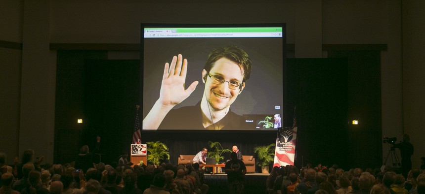 NSA leaker Edward Snowden appears on a live video feed broadcast from Moscow at an event sponsored by the ACLU Hawaii in Honolulu on Saturday, Feb. 14, 2015.