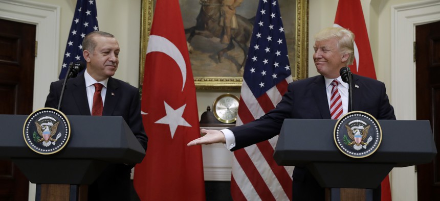 President Donald Trump reaches to shake hands with Turkish President Recep Tayyip Erdogan in the Roosevelt Room of the White House in Washington, Tuesday, May 16, 2017.