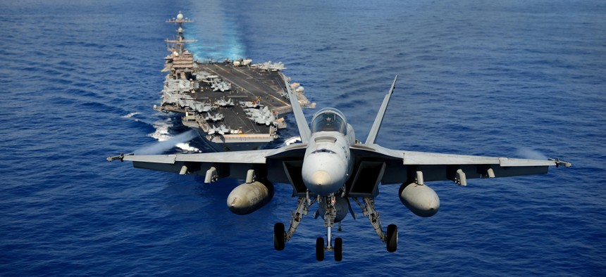 An F/A-18E Super Hornet from the Tophatters of Strike Fighter Squadron (VFA) 14 participates in an air power demonstration over the aircraft carrier USS John C. Stennis (CVN 74). 