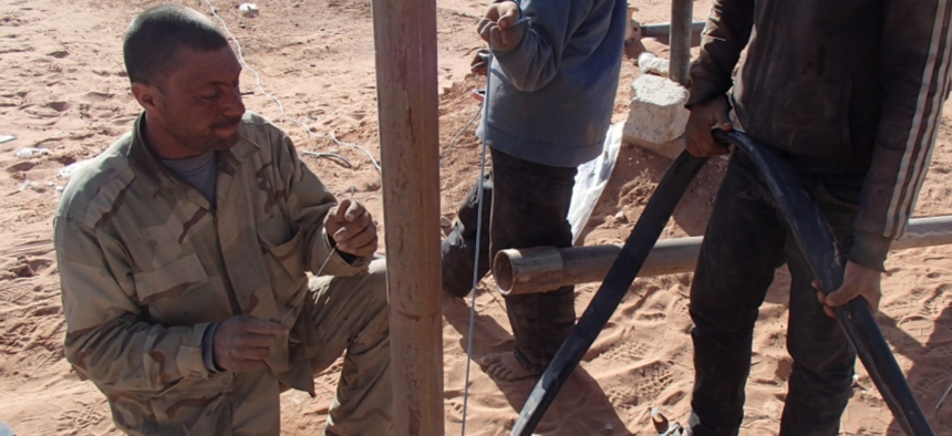 Members of Maghawir al-Thawra work to repair a water well in At Tanf Garrison in southern Syria for partner forces fighting ISIS and locals in the area. 