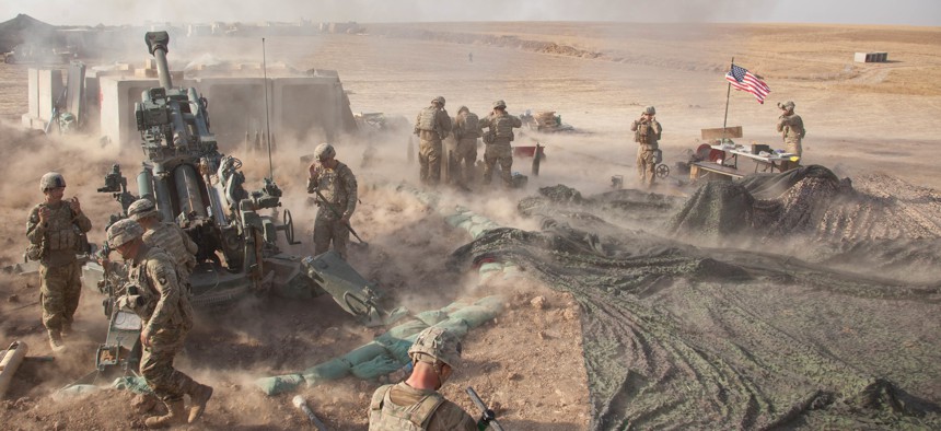 US. Army soldiers fire an M777 howitzer A2 near Mosul, Iraq, in support of the multinational effort to weaken and destroy the Islamic State.
