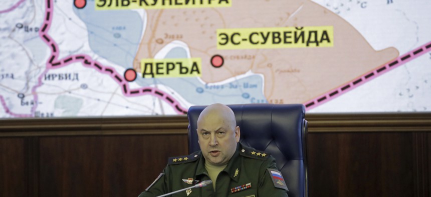 Colonel General Sergei Surovikin, Commander of the Russian forces in Syria, speaks, with a map of Syria projected on the screen in the back, at a briefing in the Russian Defense Ministry in Moscow, Russia, Friday, June 9, 2017.
