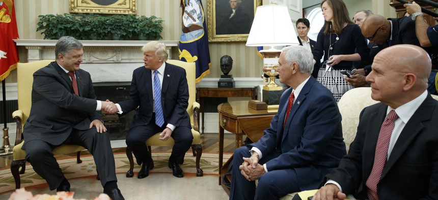 President Donald Trump shakes hands with Ukrainian President Petro Poroshenko during a meeting in the Oval Office of the White House, Tuesday, June 20, 2017, in Washington. From left, Poroshenko, Trump, Vice President Mike Pence, and H.R. McMaster.