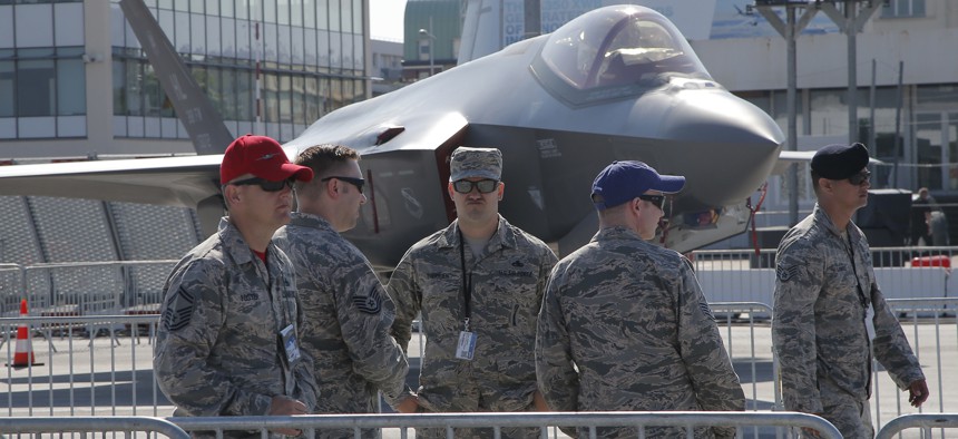 U.S. servicemen gather next to a F-35 Lightning II at Paris Air Show, on the eve of its opening, in Le Bourget, east of Paris, France, Sunday, June 18, 2017.