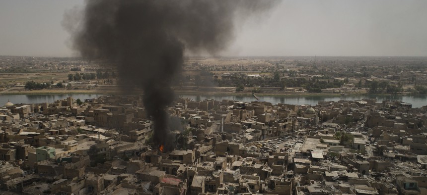 Smoke billows over the Old City after a strike as Iraqi forces continue their advance against Islamic State militants in Mosul, Iraq, Monday, July 3, 2017. 