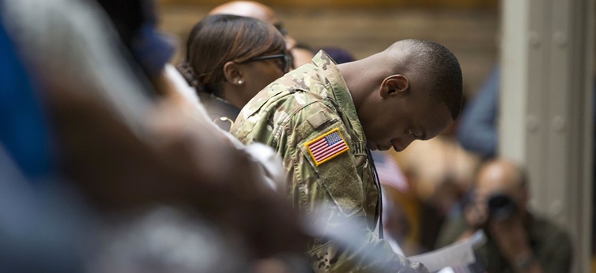 U.S. Army Specialist Shane Cardel, originally from Jamaica, bows his head after taking the Naturalization Oath of Allegiance at a ceremony in New York in late June.
