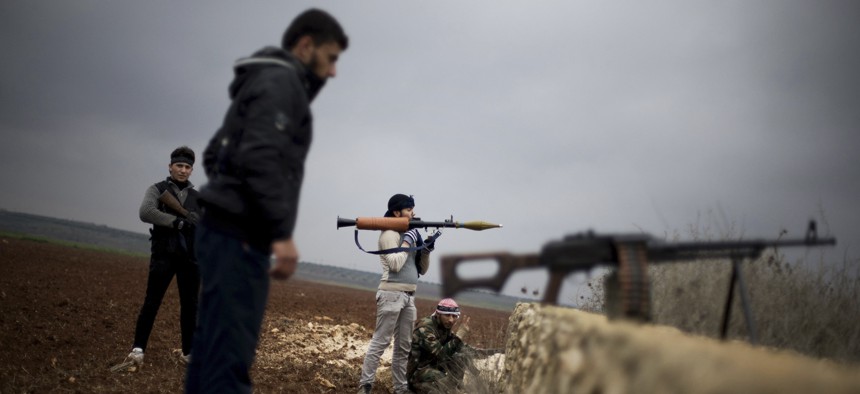 Free Syrian Army fighters take their positions, close to a military base, near Azaz, Syria, Dec. 10, 2012.