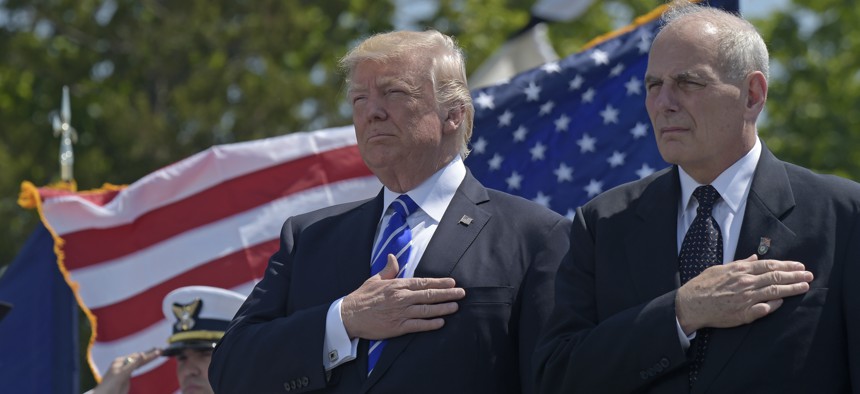 President Donald Trump and Homeland Security Secretary John Kelly listen to the national anthem during commencement exercises at the U.S. Coast Guard Academy in New London, Conn., on May 17, 2017.