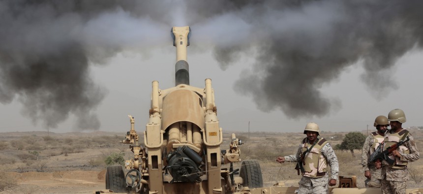 Saudi soldiers fire artillery toward three armed vehicles approaching the Saudi border with Yemen in Jazan, Saudi Arabia, on April 20, 2015.