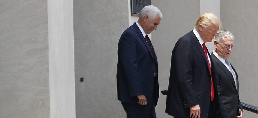 President Donald Trump and Vice President Mike Pence walk out with Defense Secretary Jim Mattis following Trump's visit to the Pentagon, Thursday, July 20, 2017.