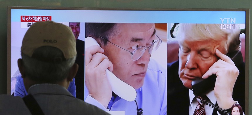 A man watches a television screen showing U.S. President Donald Trump, right, and South Korean President Moon Jae-in during a news program at the Seoul Railway Station in Seoul, South Korea, Tuesday, Sept. 5, 2017. 