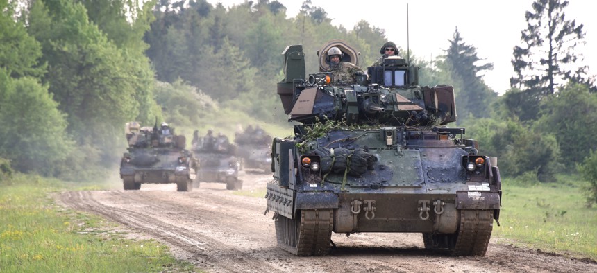 M2A3 Bradley Fighting Vehicles road march back to their tactical assemble area after a situational training exercise lane as a part of Combined Resolve VI at Hohenfels, Germany May 16, 2016.