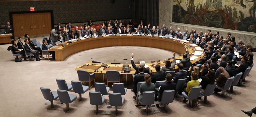 The United Nations Security Council votes on a resolution during a meeting at U.N. headquarters, Wednesday, March 2, 2016.