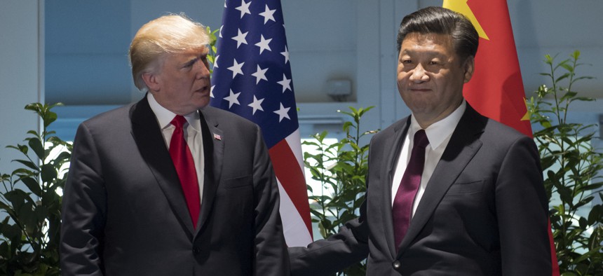 US President Donald Trump and Chinese President Xi Jinping, right, arrive for a meeting on the sidelines of the G-20 Summit in Hamburg, Germany, Saturday, July 8, 2017.