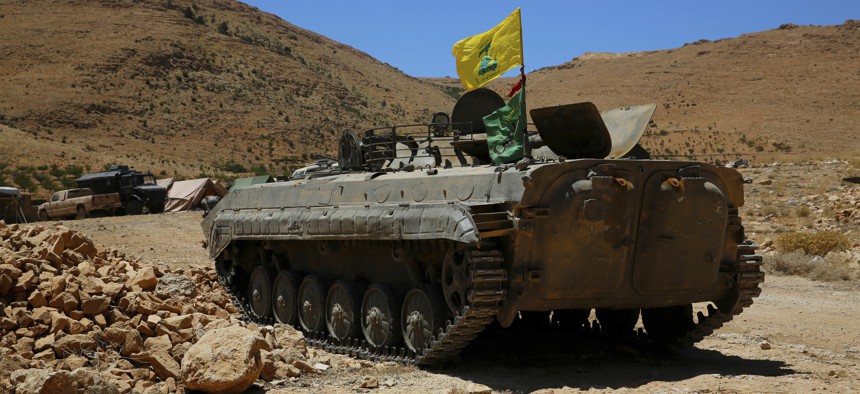 A Hezbollah armored vehicle sits at the site where clashes erupted between Hezbollah and al-Qaida-linked fighters in Wadi al-Kheil or al-Kheil Valley in the Lebanon-Syria border.
