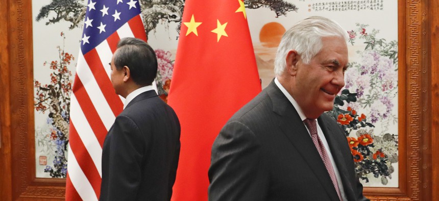 U.S. Secretary of State Rex Tillerson, right, walks by Chinese Foreign Minister Wang Yi before a meeting at the Great Hall of the People in Beijing, Saturday, Sept. 30, 2017.