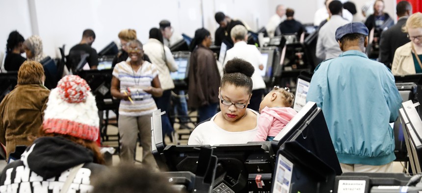 Early voters use electronic ballot casting machines at the Franklin County Board of Elections, Monday, Nov. 7, 2016, in Columbus, Ohio. 