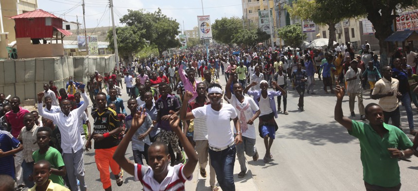Angry protesters march near the scene of Saturday's massive truck bomb attack in which over 300 people were killed in Mogadishu, Somalia, Wednesday, Oct. 18, 2017.