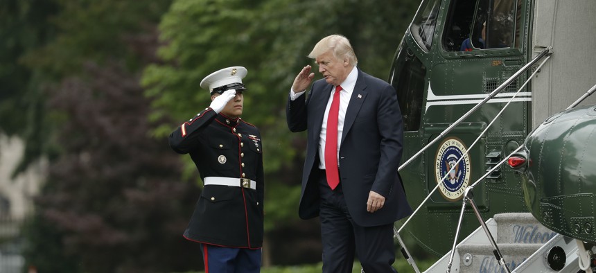 In this June 2017 photo, President Donald Trump is saluted by a Marine as he steps off the presidential helicopter at the White House.