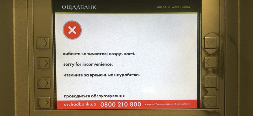 A screen of an idle virus affected cash machine in a state-run OshchadBank says "Sorry for inconvenience/Under repair" in Kiev, Ukraine, Wednesday, June 28, 2017. 