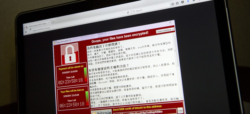 A screenshot of the warning screen from a purported ransomware attack, as captured by a computer user in Taiwan, is seen on a laptop in Beijing, May 13, 2017.