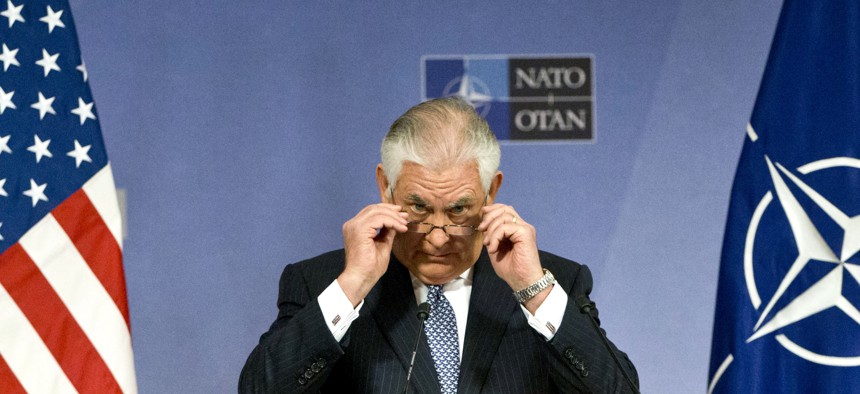 U.S. Secretary of State Rex Tillerson adjusts his glasses as he speaks during a media conference at NATO headquarters in Brussels on Wednesday, Dec. 6, 2017.