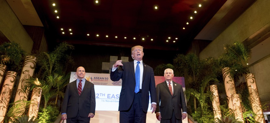 President Donald Trump, accompanied by Secretary of State Rex Tillerson, right, and National Security Adviser H.R. McMaster, speaks to the media at the Philippine International Convention Center, Nov. 14, 2017, in Manila.