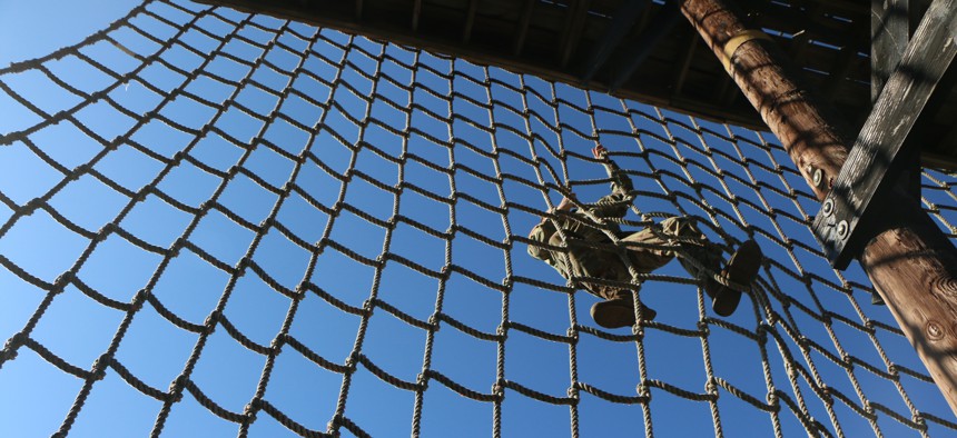 A U.S. Army officer climbs the cargo net obstacle at the 3rd Annual Thornsbury Challenge during Marne Week, Nov. 15, 2017 at Fort Stewart, Ga. 