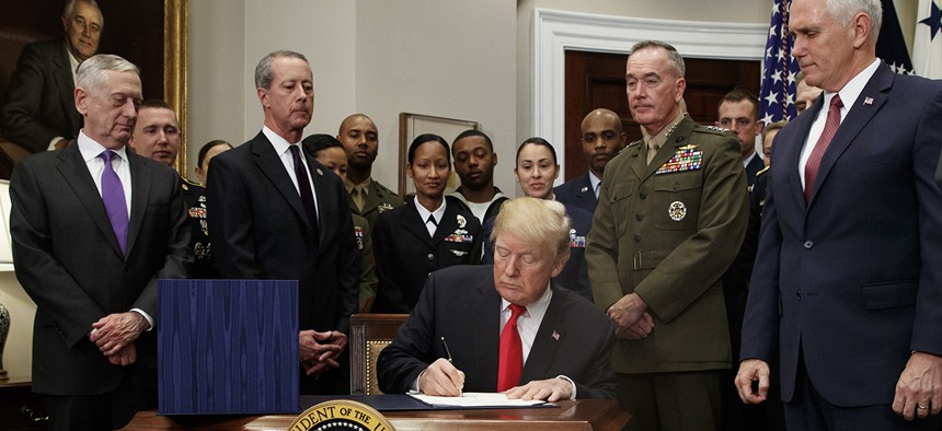 President Donald Trump signs the National Defense Authorization Act for Fiscal Year 2018, in the Roosevelt Room of the White House, Tuesday, Dec. 12, 2017.