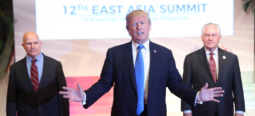 Lt. Gen. H.R. McMaster, left, and Secretary of State Rex Tillerson, right, with President Donald Trump at the East Asia Summit, Nov. 14, 2017, in Manila, Philippines.