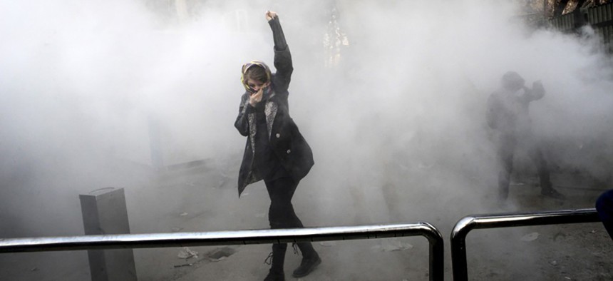 Students attend a protest at Tehran University, where a smoke grenade was thrown by anti-riot Iranian police on December 30, 2017.