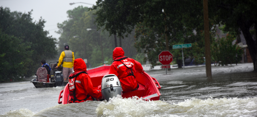 Coast Guard petty officers pilot a 16-foot flood punt boat and join good Samaritans in patrolling a flooded neighborhood in Friendswood, Texas after Hurricane Harvey.