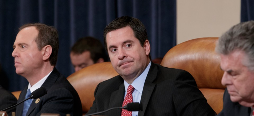 House Intelligence Committee Chairman Devin Nunes, flanked by the committee's ranking member Adam Schiff and Peter King, listens during a hearing on allegations of Russian interference in the 2016 election.