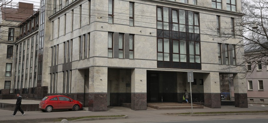 n this file photo taken on Sunday, April 19, 2015, a women enters the four-storey building known as the "troll factory" in St. Petersburg, Russia.