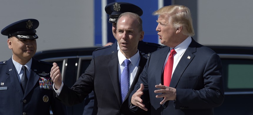 President Donald Trump talks with Boeing CEO Dennis Muilenburg upon his arrival on Air Force One at Charleston International Airport in North Charleston, S.C.,  in February 2017.