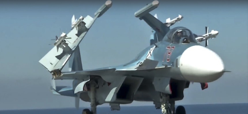 n this photo made from the footage taken from Russian Defense Ministry official web site on Tuesday, Nov. 15, 2016, a Russian Su-33 fighter jet stands on the flight deck of the Admiral Kuznetsov aircraft carrier in the eastern Mediterranean Sea. 