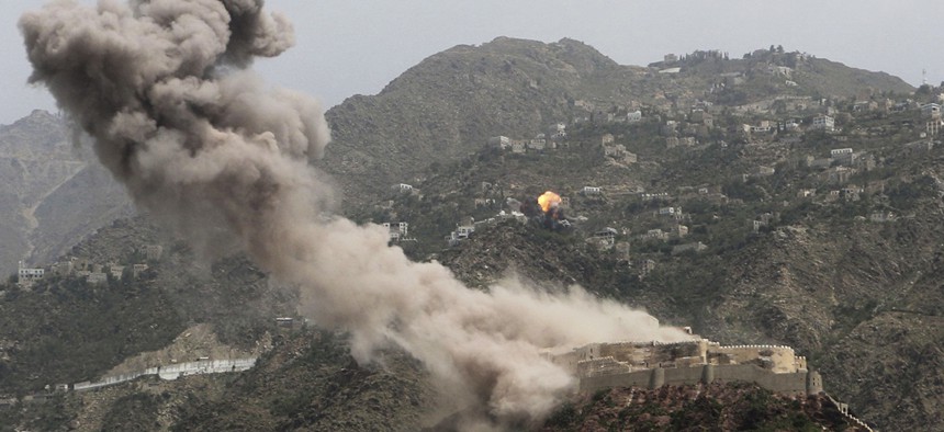 Smoke rises from al-Qahira castle, an ancient fortress near the Saber mountain, in the background, after Saudi-led air strikes in Taiz city, Yemen, May 2015. 
