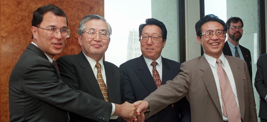 Officials from the U.S., South Korea, China, and North Korea shake hands on Aug. 5, 1997, in New York before the start of preparatory talks.