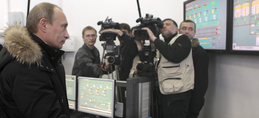 Vladimir Putin clicks on a computer mouse to fill a Russian tanker bound for Hong Kong at the terminal in the far eastern port of Kozmino, on Monday, Dec. 28, 2009