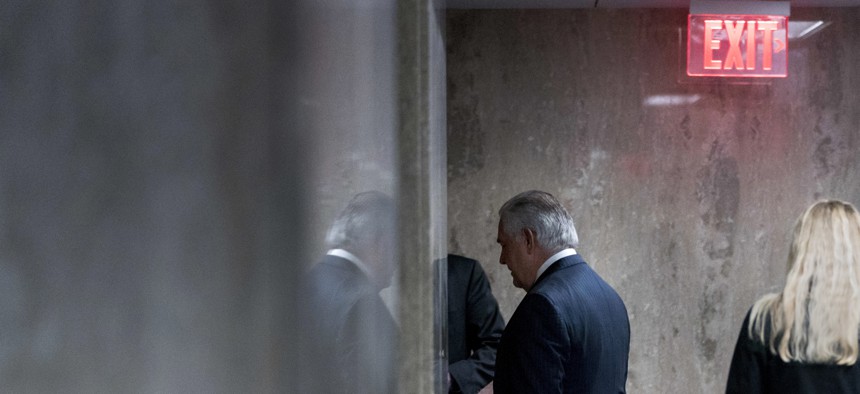 Secretary of State Rex Tillerson walks down a hallway after speaking at a news conference at the State Department in Washington, Tuesday, March 13, 2018.